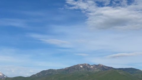 Mt. Timpanogos, Wasatch Range, Utah. Mountain range on sunny afternoon with scattered clouds. Heber Valley, Utah, USA. Time lapse with clouds.