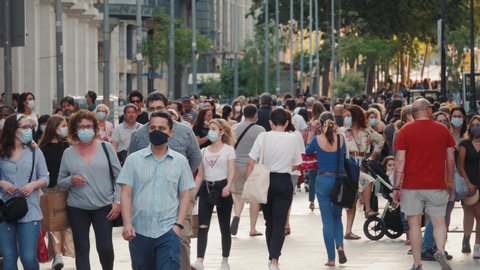 BARCELONA, SPAIN 30 MAY 2020: People crowd in city center after quarantine is over, tourists and citizens in masks, life after covid, first days, pandemic end, reopen of business