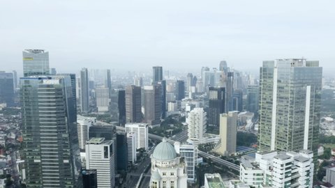 JAKARTA - Indonesia. May 19, 2020: Aerial view of Jakarta city with empty roads during quarantine for prevention coronavirus. Shot in 4k resolution from drone flying forwards