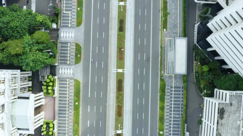 JAKARTA - Indonesia. May 19, 2020: Top down view of quiet traffic during quarantine for prevention coronavirus in Jakarta city. Shot in 4k resolution from drone flying forwards
