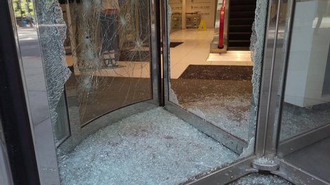 Chicago, IL / USA - May 31, 2020: Shattered Glass from Revolving Door in City After Riots/Looting