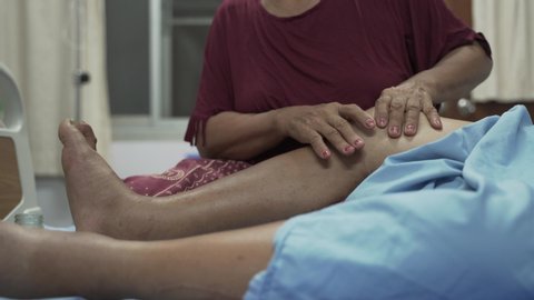 Hands massaging swollen leg, ankle and feet for Edema patient