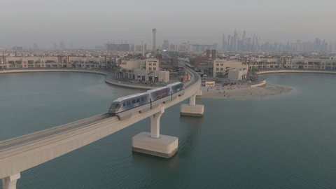 Drone video shot of tram passing on Dubai Mono rail bridge, Palm Jumeirah monorail train on January 12,2019 in Dubai, United Arab Emirates. Dubai tram 