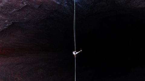 Extreme sport of slacklining, top view on a man walking the tightrope, 4k