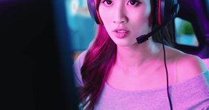 close up of Young Asian Pro Gamer Girl Playing in Online Video Game at home