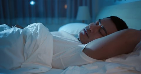 asian man sleep well with smile at night
