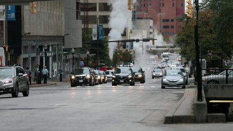BALTIMORE, MARYLAND - SEPTEMBER 29, 2019: Traffic in Baltimore City Street and Steam Pipes, Cars Driving Out of The Parking Garage in Background. Maryland State
