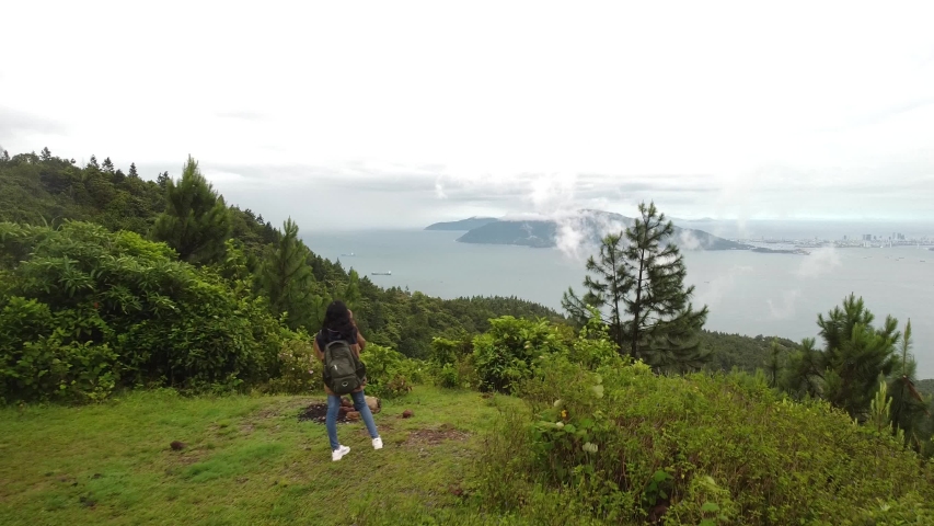 Drone fly over a beautiful natural scenery with a tourist taking photos.