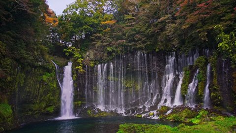 Wide shot of Shiraito waterfall with rainbow in Autumn, Japan