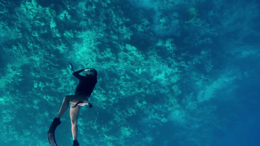 Female dives into the depth, high angle view. Free diver floats to the bottom of the sea Royalty-Free Stock Footage #1053727625