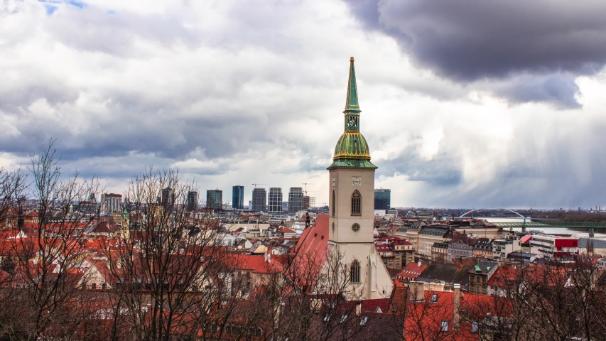 Time lapse of the landscape of the city of Bratislava from above. Shot in choppy weather with rain and sunshine at the same time. 