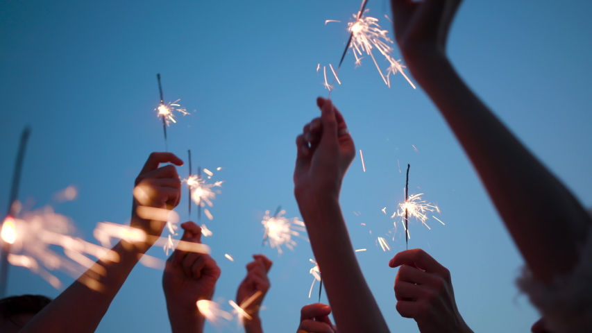Carefree Millennial Girls and Guys Students Hang Out Nature. Real Fun with Vibrant Color of Glow Burn Sparklers in Holding Hands. Male and Women Casual Funky Celebrate. Bengal Flicker Blurred Bokeh 4k | Shutterstock HD Video #1053740318