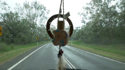 Dreamcatcher in Van driving on a rainy day in Queensland Australia. Vanlife Dreamcatcher Campervan Cape Tribulation Sea Side Road Driving in the rain. Car Freshner. Screen wiper blades
