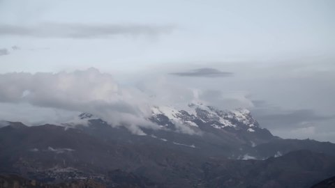 A snowy mountain covered by clouds