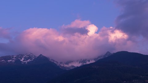 Time lapse of a spectacular sunset over the snowy peaks on the Italian Alps. 4K