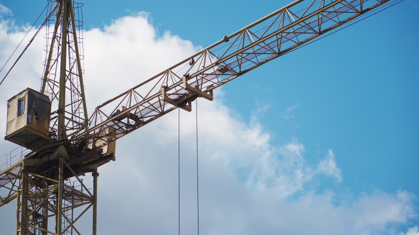 The work of a construction crane. Building on sky background. Close up. Royalty-Free Stock Footage #1053755432