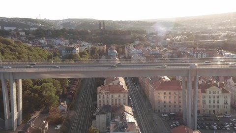 Aerial drone view of highway multi-level junction road with moving cars at sunset. Cars are moving on a multi-level road junction The concept of the urban. Prague, Czechia