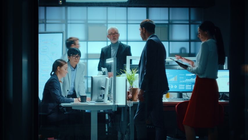 Footage from Outside the Window: Businessmen and Businesswomen Working in the Office. Managers are Having a Business Meeting and Discuss Future Financial Plans and Next Quarter Overseas Development. | Shutterstock HD Video #1053766775