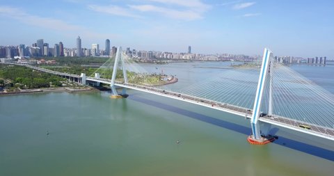 Haikou, Hainan, China - June 1st 2020: Cityscape with Century Bridge, the Cross-sea Cable Stayed Bridge Connecting Downtown Haikou City and Haidian Peninsula Area.