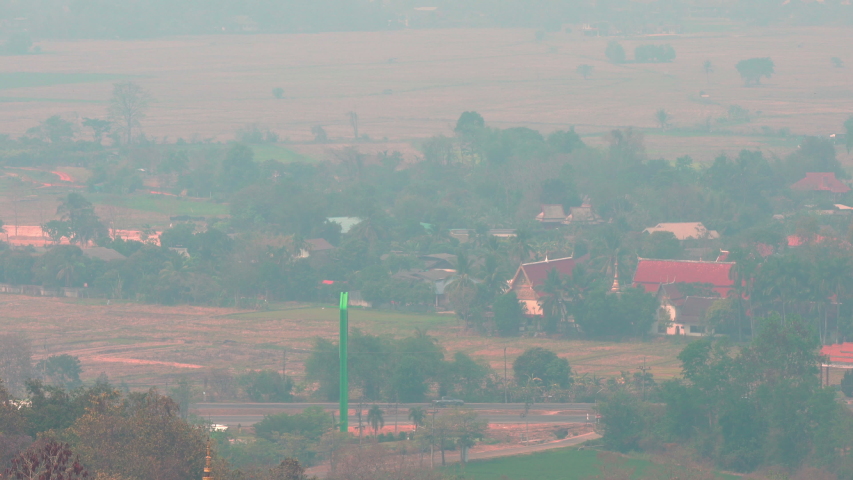 Buddhist Thailand temple in the background of smoke enveloping popular tourist city of Chiang Mai. Continuous fires regularly promote this city to first place in the world in the rank of air pollution