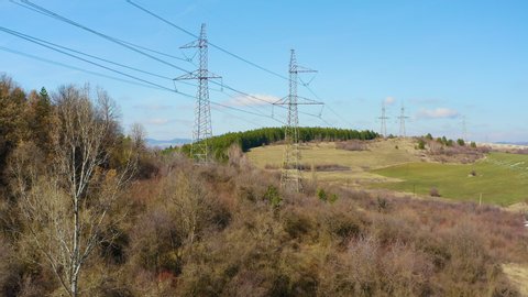Aerial drone footage of transmission electricity steel pylon tower. Sunset motion shot
