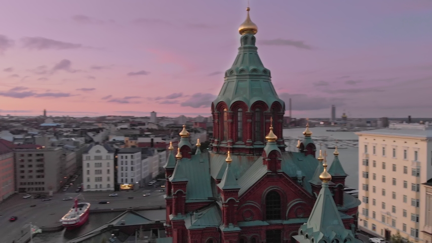 Tours in Helsinki. The European Union. Sunset sky and clouds and Helsinki Uspenski Cathedral with colourful buildings. Helsinki, Finland. Royalty-Free Stock Footage #1053773786