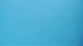 Paper airplane appears on a blue background. The art of folding things out of paper. Stop motion. HD video