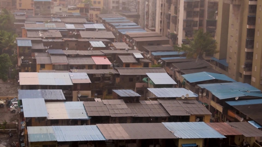 Mumbai, Maharashtra / India - 3 June 2020: Cyclone Nisarga (Nature) hits Mumbai city slums homes houses roofs with heavy rain & extreme winds. Nisarg tropical Storm makes landfall with gust of winds