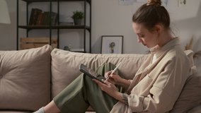 Art of young woman drawing ecological painting by stylus close-up indoor. Talented artist sketching color image of flowerpot and plant at screen of digital pad. Girl writes "Keep our planet" at tablet - Powered by Shutterstock - Get 15% off with code: PIKWIZARD15