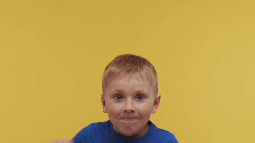 Portrait of happy smiling boy in t-shirt. Attractive and expressive kid in studio.