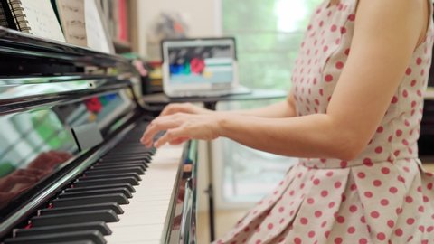 Homeschooling piano online lesson performing by pianist teacher, Online class from home during Corona virus or covid19 pandemic, many Education change the way to learn from online.  
