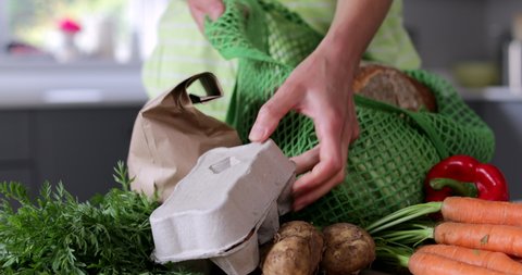 Close Up Of Woman Unpacking Local Food In Zero Waste Packaging From Bag