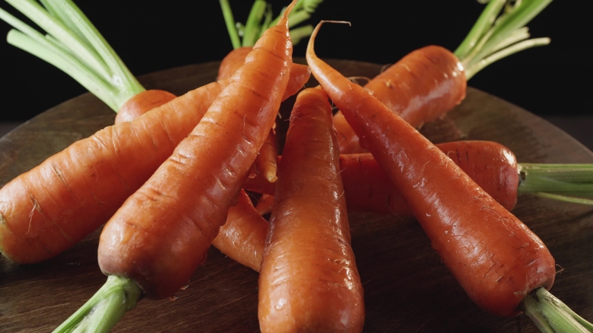 Fresh clean carrots close-up on a dark background Royalty-Free Stock Footage #1053790790