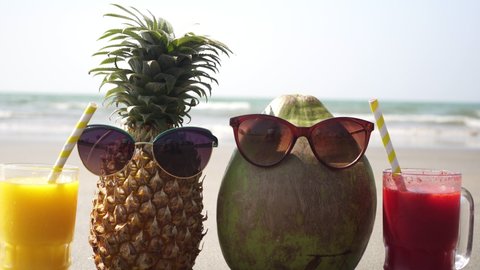 Fruit tourist family pineapple and coconut on a sandy sea beach