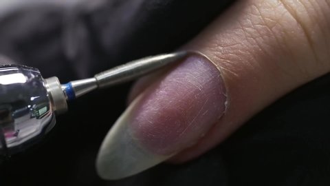 Professional manicure. Nail extension. Cutting the cuticle with a manicure machine, macro