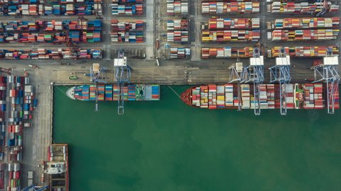 Time lapse container , Container ship in export and import business and logistics. Shipping cargo to harbor by crane. Water transport International. Aerial view and top view