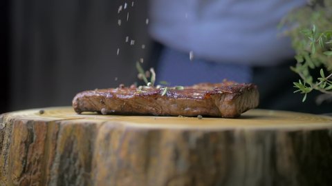 Cutting, slicing medium rare meat grilled barbecue steak with knife