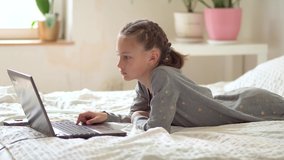 Cute child use laptop for education, online study. Girl has homework at home schooling. Lifestyle concept for Family quarantine covid-19.
