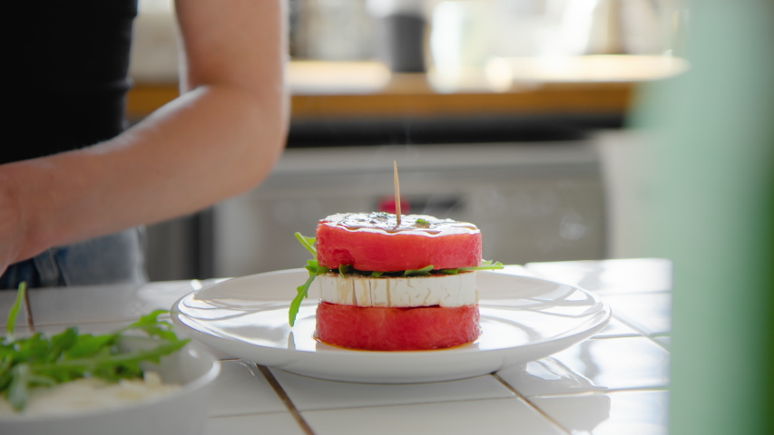 Top view on woman assemble and decorate beautiful plate of delicious fancy dish. Healthy high cuisine dish made from internet food blog recipe. Inspiring organic eating at home