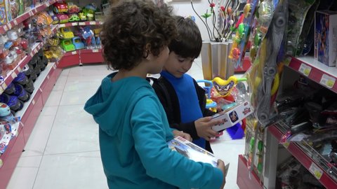 Finike, Turkey - 12th of March 2020: 4K Two kids choose presents in a toy store
