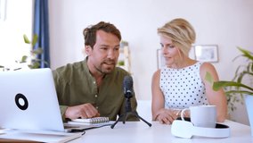 Happy couple with microphone having video call on laptop indoors at home.