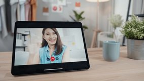 Tablet screen with Asian Beautiful woman in casual clothes video call conference chatting online on video calling app with smiling face and enjoying expression. lifestyle Communication Concept
