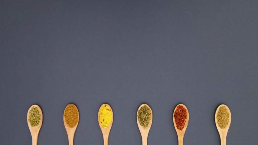 6k Wooden spoons with various spices appear on bottom - Stop motion 