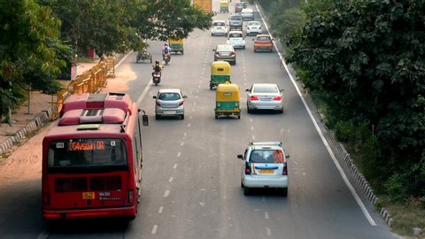 New Delhi, India - June, 2020 : Footage of vehicles on a road after unlocking in New Delhi, India. Beautiful landscape view of Indian road. Life after lockdown in India 