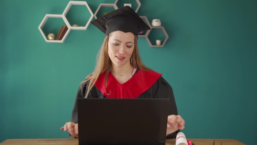 A student girl shows off her diploma to her parents via IP-telephony. Distance learning. Online learning Royalty-Free Stock Footage #1053872096