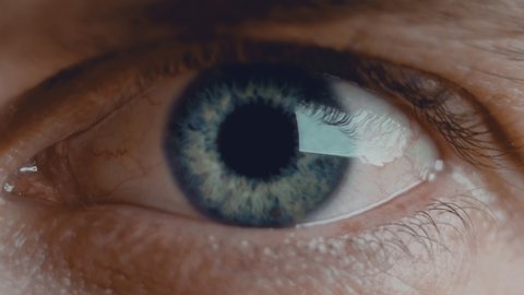 Close up shot of eye opening with beautiful blue iris. Healthy eyesight concept. Front view macro video in 4K.