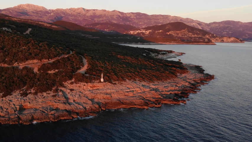 Lighthouse panoram at sunset. Flight around.