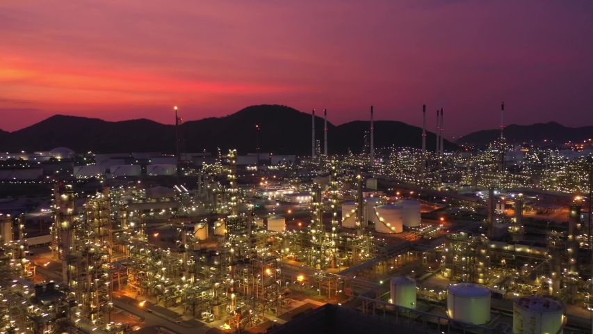 Aerial view at the refinery and oil tank at dusk. Business and petrochemical plants, oil storage tanks and for energy and steel pipes in Twilight time
 Royalty-Free Stock Footage #1053883928