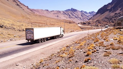 Mendoza / Argentina - April 2020: Cargo Truck on Road in the Andes Mountains, South America. 