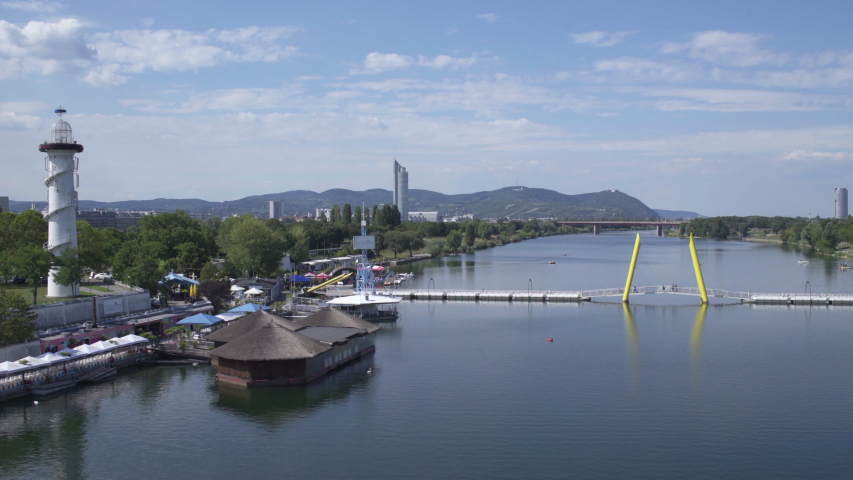 Vienna, Donauinsel park and Lighthouse, Passing a bridge over Danube river, sunny, Austria